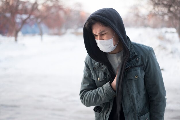 front view of sick man wearing a medical mask