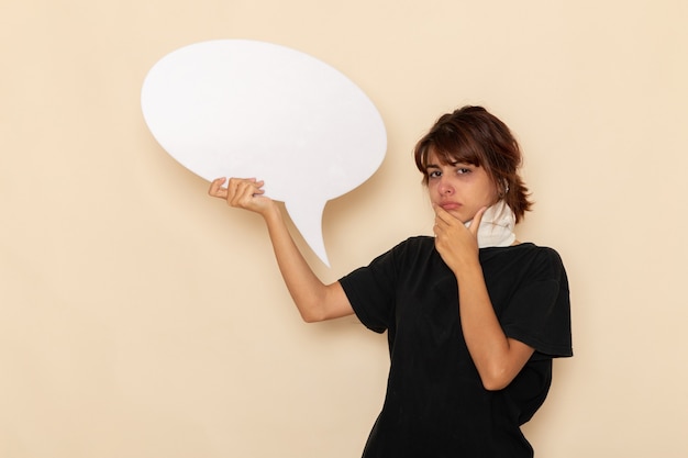 Free photo front view sick young female feeling ill holding huge white sign on light white surface