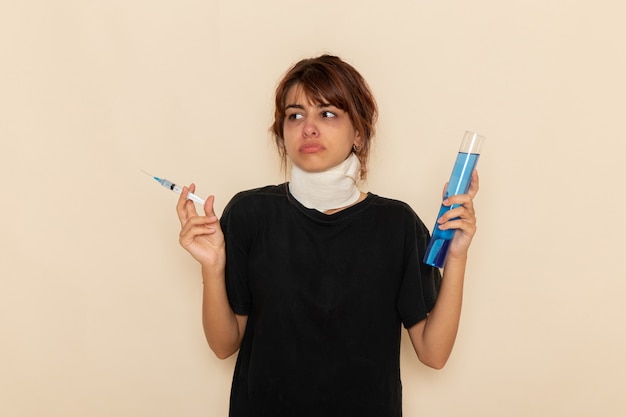 Front view sick young female feeling ill and holding injection on a white surface