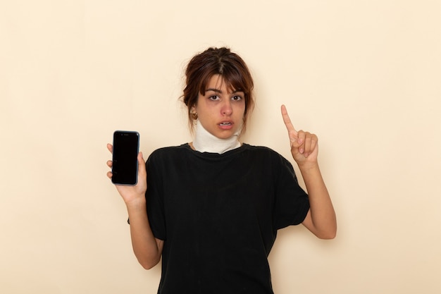 Front view sick young female feeling very ill and holding phone on white desk