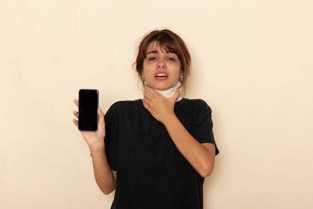 Front view sick young female feeling very ill and holding phone on white surface