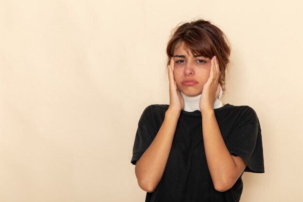 Front view sick young female with high temperature covering her throat and feeling ill on light white surface