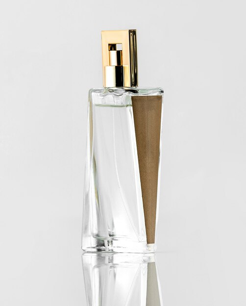 A front view silver brown designed fragrance bottle on the white desk