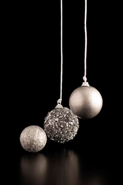 Free photo front view of silver hanging christmas globes