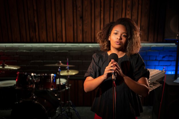 Front view singer working in a studio