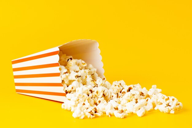 A front view slated popcorn inside package spread all on yellow