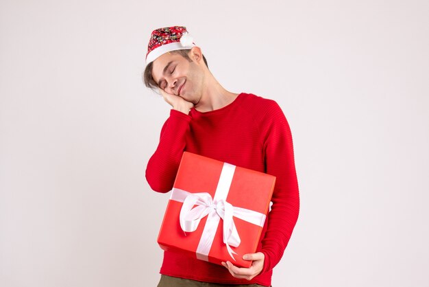 Front view sleepy man with santa hat standing on white 