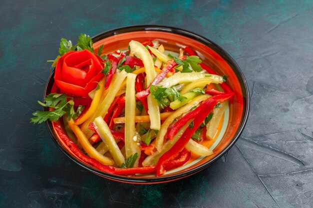 Front view sliced bell peppers different colored salad inside plate on dark surface