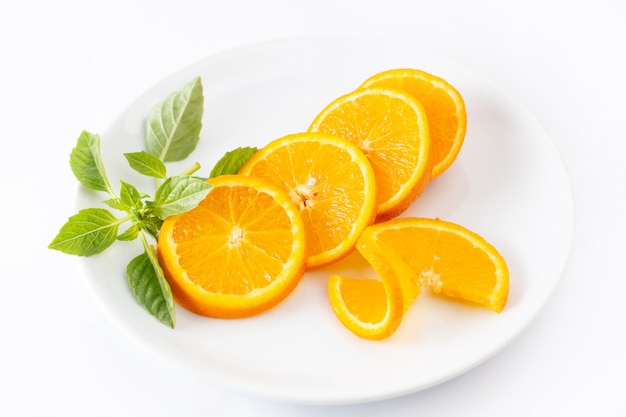 Front view sliced fresh oranges inside white plate on white