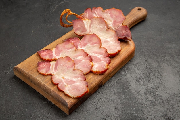 Front view sliced ham on wooden desk and grey photo color meat food meal raw pig