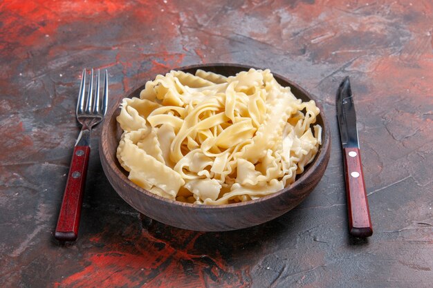 Front view sliced raw dough inside plate on dark surface dough pasta dark food