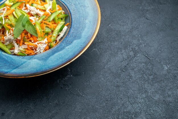 Front view sliced vegetable salad inside plate on dark-grey desk