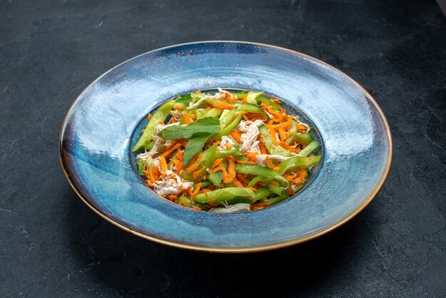 Front view sliced vegetable salad inside plate on dark-grey surface