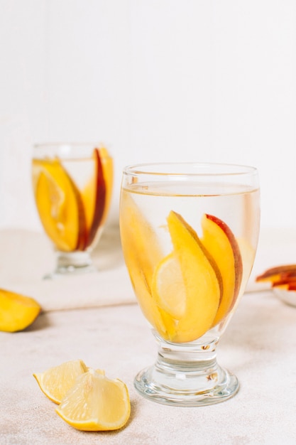 Front view slices of mango in a glass
