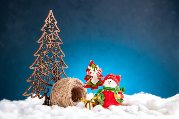 Front view small snowman toy xmas ornaments on blue background