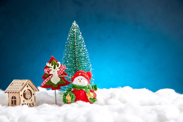 Front view small xmas toys wooden house on blue background