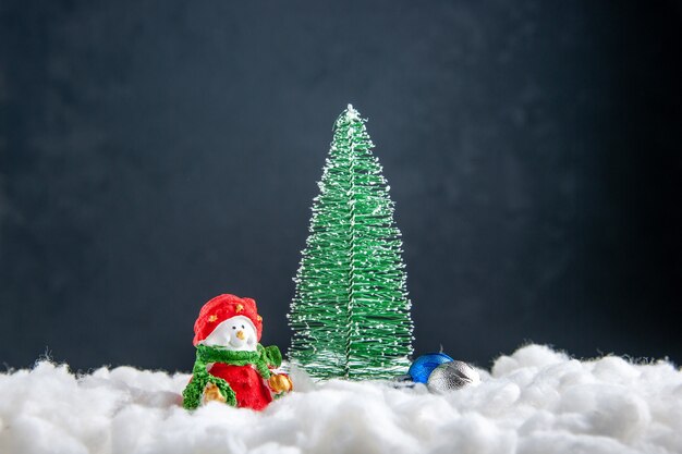 Front view small xmas tree snowman toy on dark surface