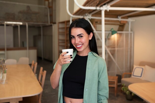 Front view smiley arab woman posing indoors