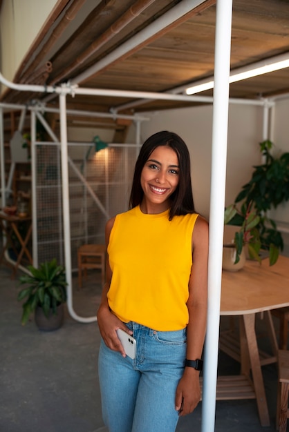 Free photo front view smiley arab woman posing indoors