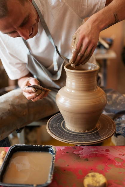 Front view smiley artisan doing pottery