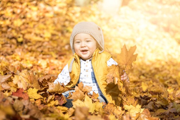 Front view smiley baby with hat outdoors