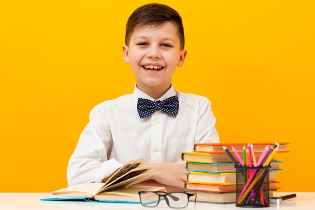 Front view smiley boy with books