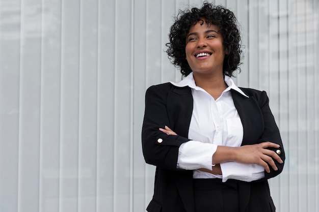 Front view smiley business woman with crossed arms