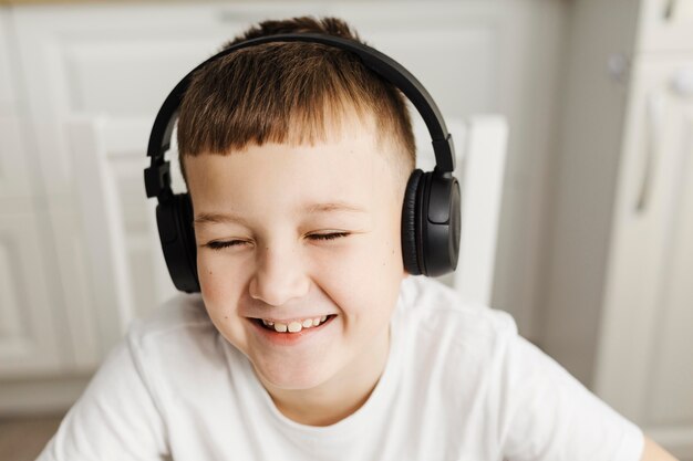 Front view smiley child wearing headphones