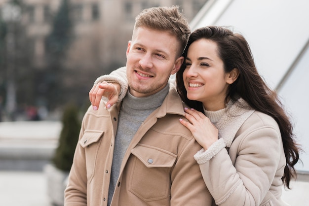 Front view of smiley couple outside