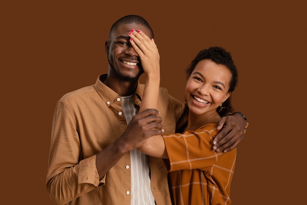 Free photo front view of smiley couple posing and having fun