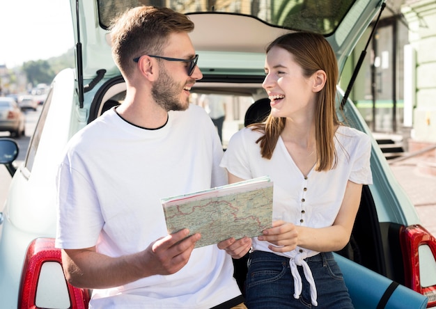 Front view of smiley couple with map