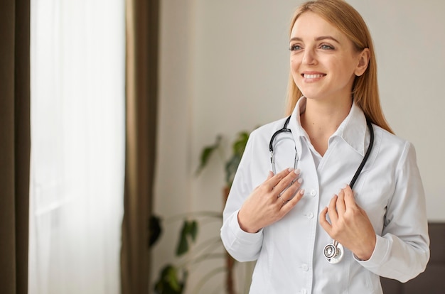 Front view of smiley covid recovery center female doctor with stethoscope