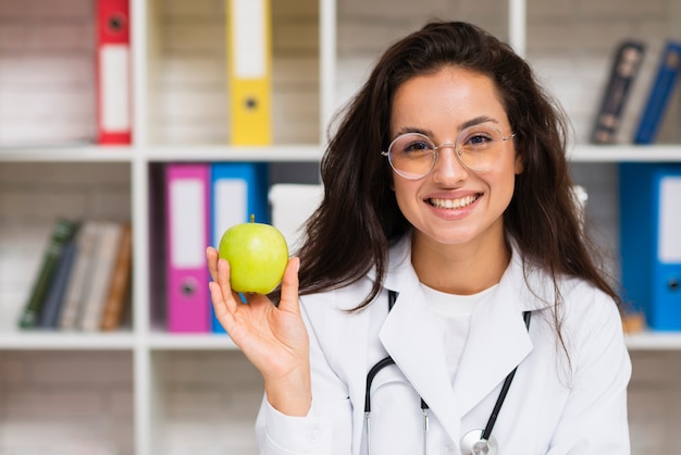 Front view smiley doctor with apple