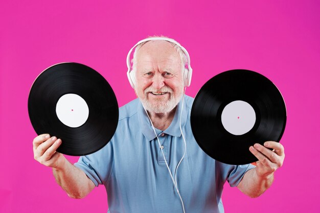 Front view smiley elder holding music records