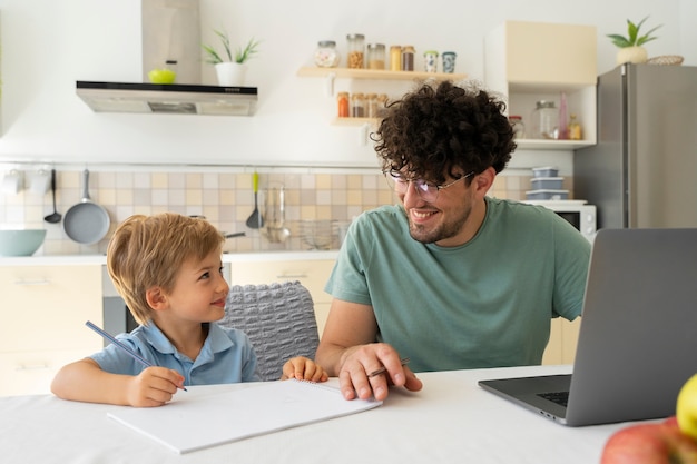 Free photo front view smiley father looking at kid