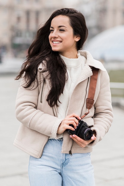 Front view of smiley female photographer