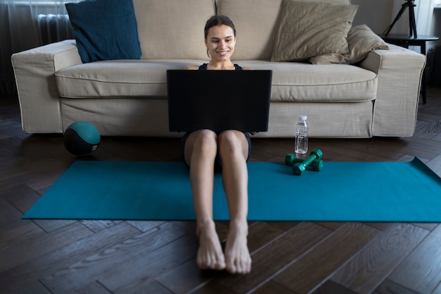 Free photo front view of smiley female with laptop