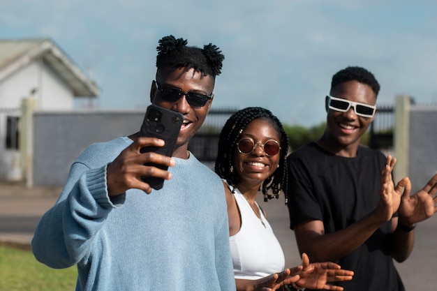 Front view smiley friends taking selfie