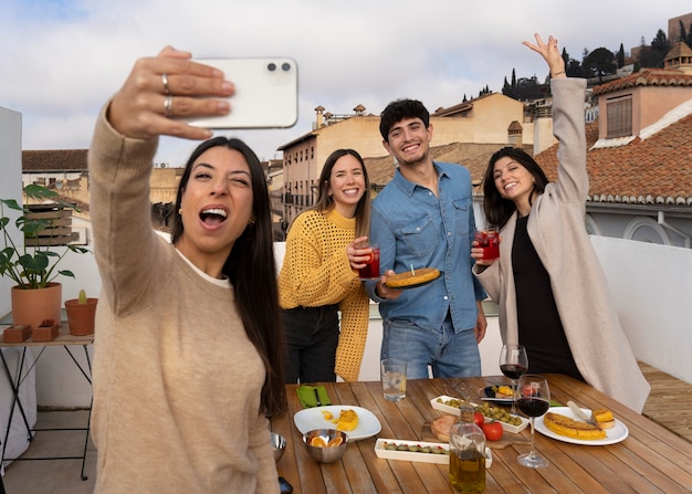 Front view smiley friends taking selfie