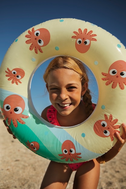 Front view smiley girl at beach