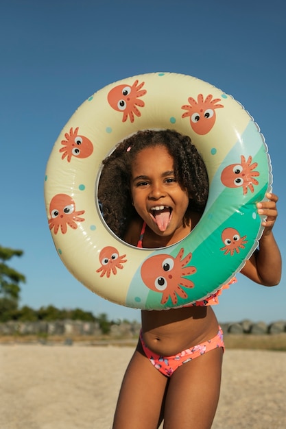 Front view smiley girl on beach