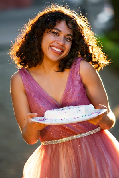 Free photo front view smiley girl holding cake