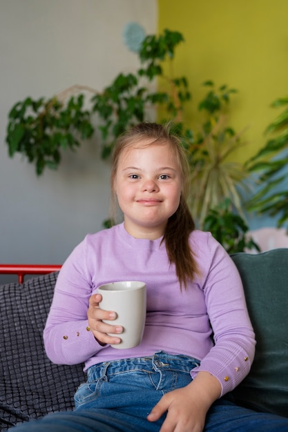 Front view smiley girl holding cup