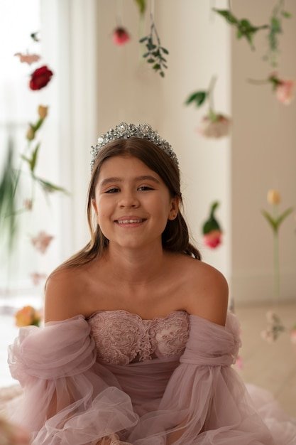 Free photo front view smiley girl wearing crown