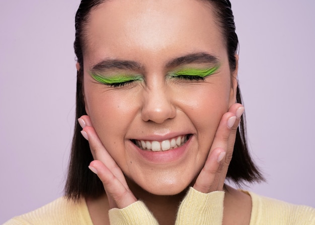 Front view smiley girl with green eye shadow