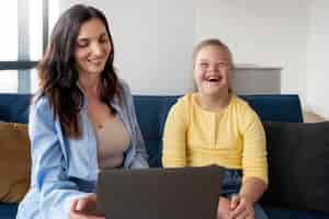 Free photo front view smiley girl and woman indoors