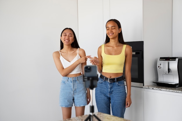 Free photo front view smiley girls recording