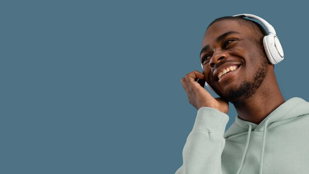 Front view of smiley handsome man with headphones and copy space