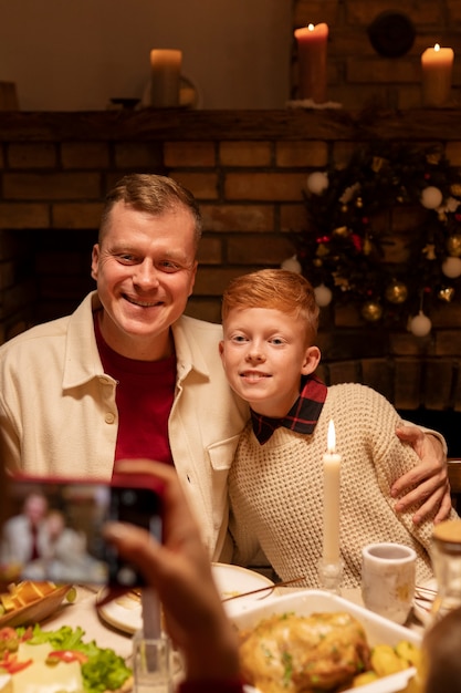 Free photo front view smiley kid and father posing