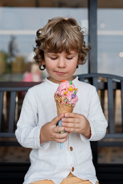 Front view smiley kid looking at ice cream